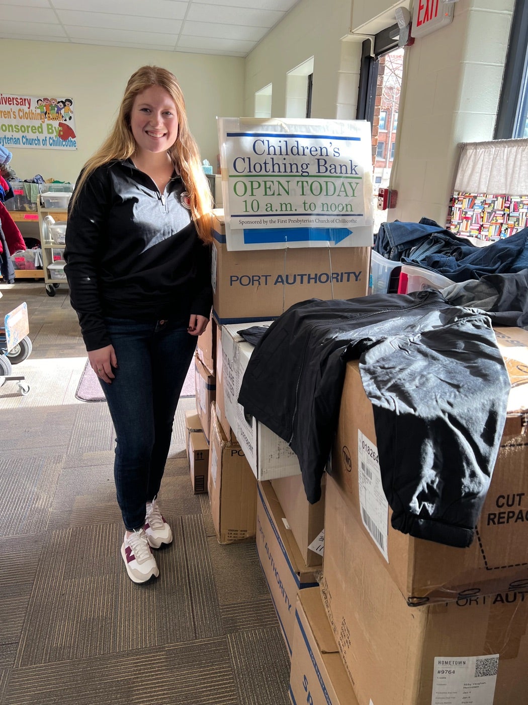 A Herrnstein team member volunteering at the Children's Clothing Bank.